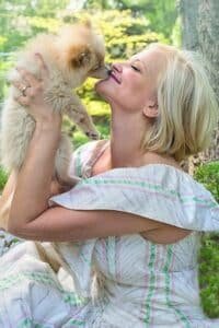 woman kissing dog